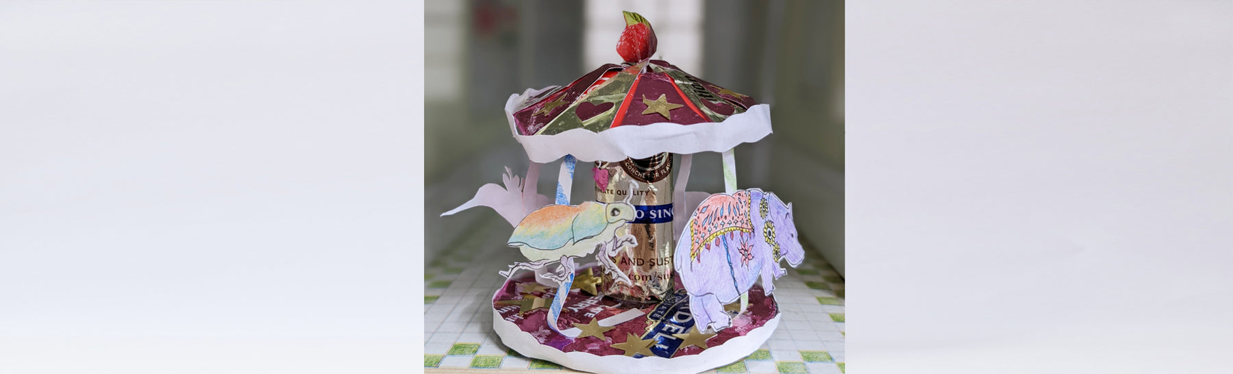 a paper sculpture with animals on a carousel