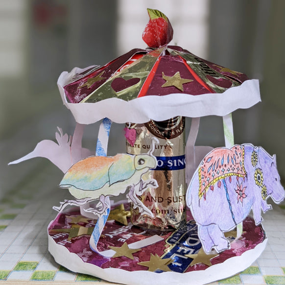 a paper sculpture with animals on a carousel